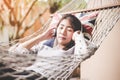 Young woman listening music relax lying in a hammock in the holiday Royalty Free Stock Photo