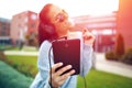 Young woman listening music on tablet by headphones Royalty Free Stock Photo