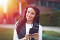 Young woman listening music on tablet by headphones in sunset Royalty Free Stock Photo