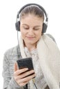 Young woman listening to music with his mobile phone and headph Royalty Free Stock Photo