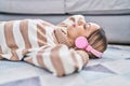 Young woman listening to music lying on floor at home Royalty Free Stock Photo