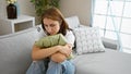 Young woman listening to music with sad expression at home Royalty Free Stock Photo