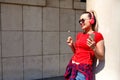 Young woman listening to music via headphones on the street Royalty Free Stock Photo