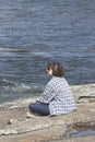 Young woman listens to music by the river Royalty Free Stock Photo