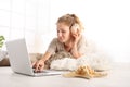 Young woman listens to the shell lying in the living room in fro Royalty Free Stock Photo