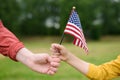 Young woman and little child holding american flag on grey background. Independence Day concept. National holiday Royalty Free Stock Photo