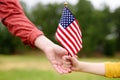 Young woman and little child holding american flag. Independence Day concept Royalty Free Stock Photo