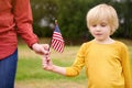Young woman and little child holding american flag. Independence Day concept Royalty Free Stock Photo