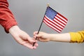 Young woman and little child holding american flag. Independence Day concept Royalty Free Stock Photo