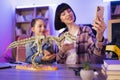 Young woman and little cute girl filming video of their scientific research. Royalty Free Stock Photo