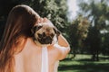 Young woman with little cute pug in her hands Royalty Free Stock Photo