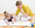 Young woman and little girl drawing