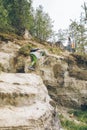 young woman with little toddler boy climbing by rocks Royalty Free Stock Photo