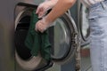 Young woman loading washing machine in dry-, closeup Royalty Free Stock Photo