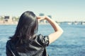 Young woman with long black hair looking at the water in the city Royalty Free Stock Photo