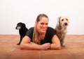 Smiling woman on floor with two dogs Royalty Free Stock Photo