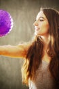 Young woman with long brown hair playing with purple ball. Royalty Free Stock Photo