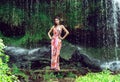 Young woman in a long dress near a waterfall Royalty Free Stock Photo