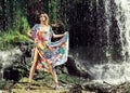 Young woman in a long dress near a waterfall Royalty Free Stock Photo