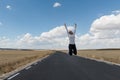 Young woman jumping on the road on nowhere Royalty Free Stock Photo