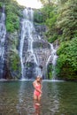 Young woman in swimsuit in front of Banyumala twin waterfalls on Bali Royalty Free Stock Photo