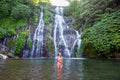 Young woman in swimsuit in front of Banyumala twin waterfalls on Bali Royalty Free Stock Photo