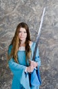 Young woman with long hair poses with sword Royalty Free Stock Photo