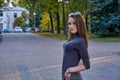 A young woman with long hair in a turtleneck, shorts and boots on a walk a park Royalty Free Stock Photo