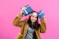 young woman in long-sleeved shirt with fluffy coat because cold on christmas night, hold gift box in hand look Royalty Free Stock Photo