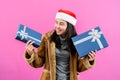 young woman in long-sleeved shirt with fluffy coat because cold on christmas night, hold gift box in hand look delighted receiving Royalty Free Stock Photo