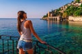 Young woman look on ancient shipyard from Kizil Kule tower in Alanya peninsula, Antalya district, Turkey, Asia. Famous tourist Royalty Free Stock Photo