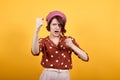 Young woman looking angry raising fists and furious while shouting with anger Royalty Free Stock Photo