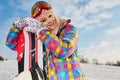 Young woman looking away while holding snowboard in snow Royalty Free Stock Photo