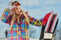 Young woman looking away while holding snowboard in snow Royalty Free Stock Photo