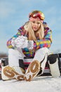 Young woman looking away while holding snowboard in snow Royalty Free Stock Photo
