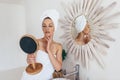 Young woman looking in the bathroom mirror Royalty Free Stock Photo