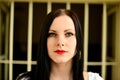 Young woman looking from behind the bars Royalty Free Stock Photo