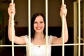 Young woman looking from behind the bars Royalty Free Stock Photo