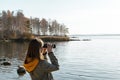 Young woman looking through binoculars at birds on lake Birdwatching, zoology, ecology. Research in nature, observation of animals Royalty Free Stock Photo