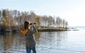 Young woman looking through binoculars at birds on lake Birdwatching, zoology, ecology. Research in nature, observation of animals Royalty Free Stock Photo