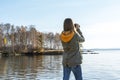 Young woman looking through binoculars at birds on lake Birdwatching, zoology, ecology. Research in nature, observation of animals Royalty Free Stock Photo