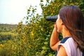 Young woman looking through binoculars Royalty Free Stock Photo