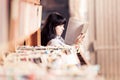 Young Woman Looking At Books In A Bookstore Royalty Free Stock Photo