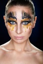 Young woman looking at the camera with fantasy make up face art studio shot. Royalty Free Stock Photo
