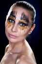 Young woman looking at the camera with fantasy make up face art studio shot. Royalty Free Stock Photo