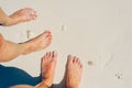 Young woman looking down of view perspective on bare feet standing in white sand Royalty Free Stock Photo