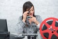 Young woman looking at film slide with magnifying glass Royalty Free Stock Photo