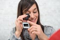 Young woman looking at film slide with magnifying glass Royalty Free Stock Photo