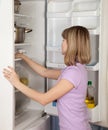 Young woman looking in fridge Royalty Free Stock Photo