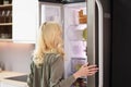 Young woman looking in fridge Royalty Free Stock Photo